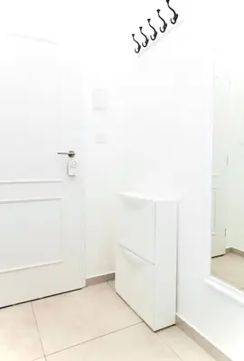 a white bathroom with a toilet and a mirror at Prague Old Town Residence in Prague