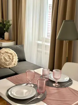 a table with plates and glasses on top of it at Prague Old Town Residence in Prague