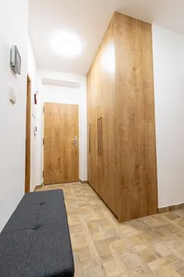 a room with a bed and a wooden closet at Spoon Apartment Prague 1A in Prague