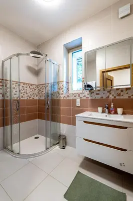 a bathroom with a shower and a sink at Spoon Apartment Prague 1A in Prague