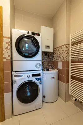 a washer and dryer in a kitchen with a washing machine at Spoon Apartment Prague 1A in Prague