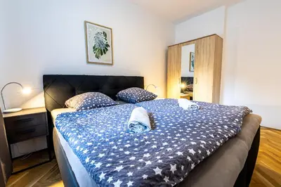 a bedroom with a bed with a blue comforter at Spoon Apartment Prague 1A in Prague