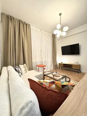 a living room with a couch and a table at Rentero National Theatre Apartment with 2 Bathrooms Prague City Center in Prague