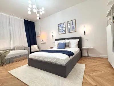 a bedroom with two beds and a couch in it at Rentero National Theatre Apartment with 2 Bathrooms Prague City Center in Prague