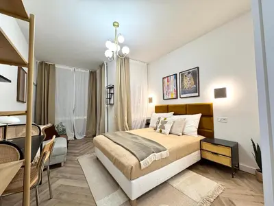 a bedroom with a bed and a desk in a room at Rentero National Theatre Apartment with 2 Bathrooms Prague City Center in Prague