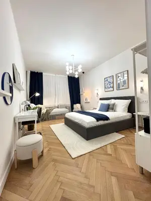 a bedroom with a bed and a living room at Rentero National Theatre Apartment with 2 Bathrooms Prague City Center in Prague