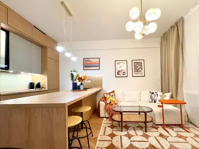 a kitchen and living room with a couch and a table at Rentero National Theatre Apartment with 2 Bathrooms Prague City Center in Prague
