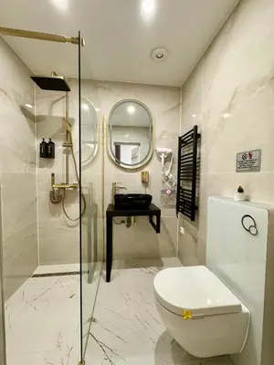 a bathroom with a toilet and a glass shower at Little Downtown Apartment in Prague