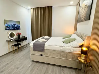a bedroom with a large bed and a desk at Little Downtown Apartment in Prague