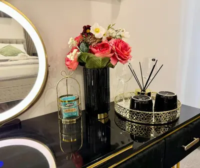 a vase with flowers on a table in a bathroom at Little Downtown Apartment in Prague