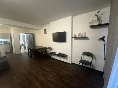 a living room with a table and chairs and a television at Budget Dlouha Apartment in Prague