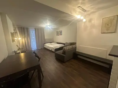 a small living room with a bed and a couch at Budget Dlouha Apartment in Prague