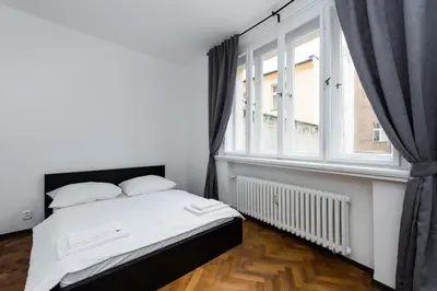 a bedroom with a bed and a large window at Affordable Stay Navratilova in Prague