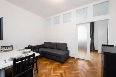 a living room with a couch and a table at Affordable Stay Navratilova in Prague