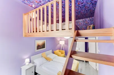 a small room with a bunk bed and a staircase at Place of Grace - 3 minutes from the Museum and Old Town in Prague
