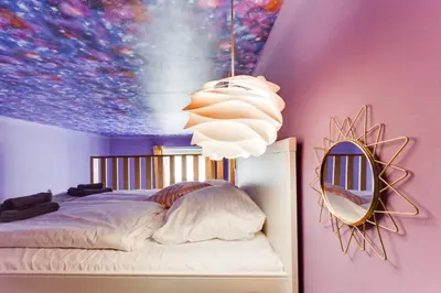 a bedroom with a bed with a painting on the wall at Place of Grace - 3 minutes from the Museum and Old Town in Prague