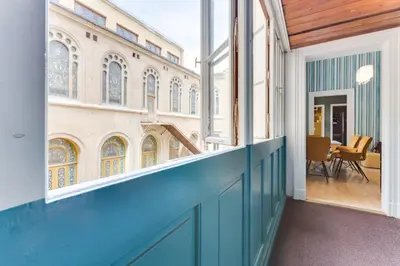 an open balcony with a view of a building at Place of Grace - 3 minutes from the Museum and Old Town in Prague