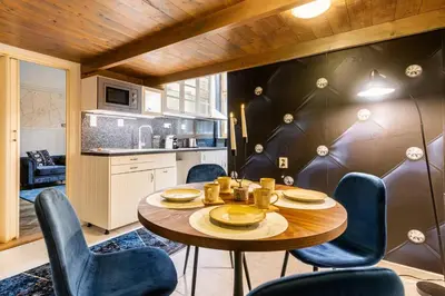 a kitchen with a table and chairs in a room at Place of Grace - 3 minutes from the Museum and Old Town in Prague
