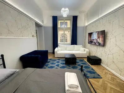 a bedroom with a bed and a couch at Place of Grace - 3 minutes from the Museum and Old Town in Prague