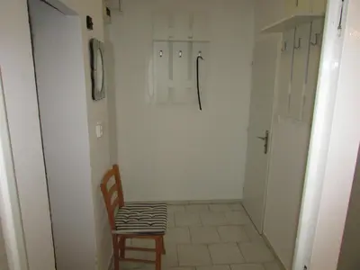 a small hallway with a chair and a door at PragueCityApartment in Prague