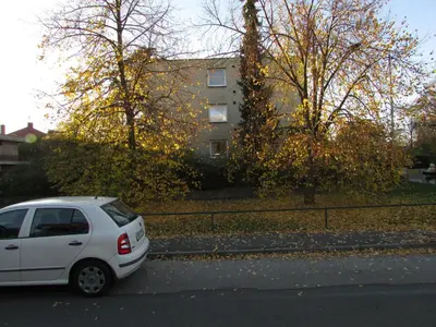 a white car parked on the side of a street at PragueCityApartment in Prague