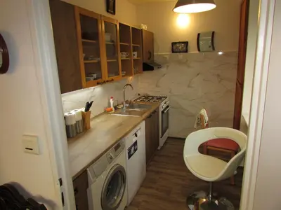 a kitchen with a sink and a washing machine at PragueCityApartment in Prague