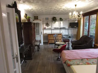 a bedroom with a bed and a living room at PragueCityApartment in Prague