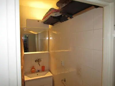 a bathroom with a sink and a mirror at PragueCityApartment in Prague