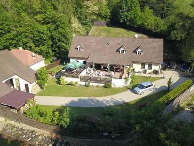 an aerial view of a house with a car parked in the driveway at Penzion Hájovna U Dubu in Karlštejn