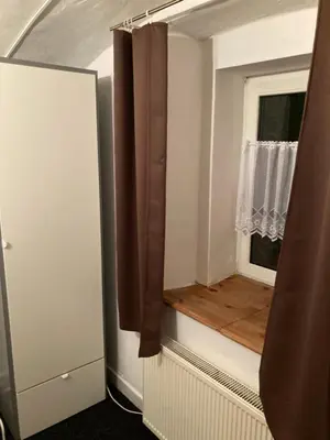 a small room with a window with a wooden floor at Ubytování Hoštka in Hošťka