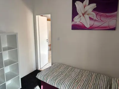 a bedroom with a bed and a painting on the wall at Ubytování Hoštka in Hošťka