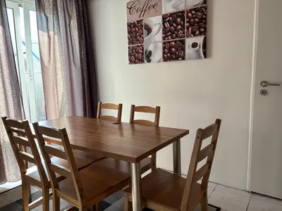 a wooden table and chairs in a room at Ubytování Hoštka in Hošťka