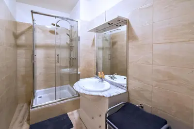 a bathroom with a sink and a shower at Apartments Vezenska in Prague