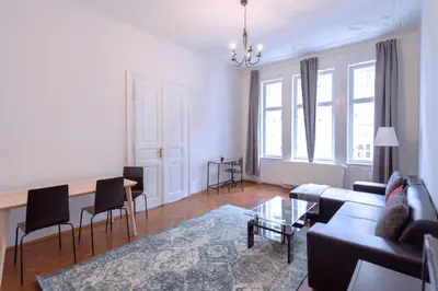 a living room with a couch and a table at Apartments Vezenska in Prague