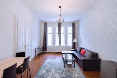 a living room with a couch and a table at Apartments Vezenska in Prague
