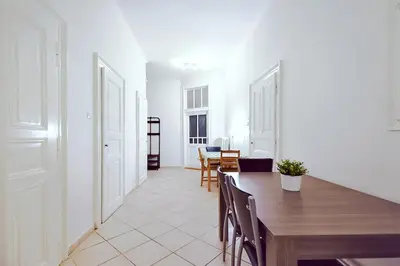 a dining room with a wooden table and chairs at Apartments Vezenska in Prague