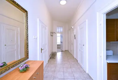 a hallway of a home with a mirror at Apartments Vezenska in Prague