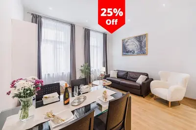 a living room with a table and a couch at Premiere Dubcek Apartment in Prague