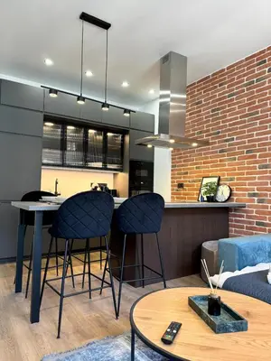 a kitchen and living room with a table and chairs at Rentero modern Apartment, 10 minutes Charles bridge, Prague in Prague