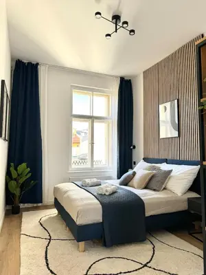 a bedroom with a large bed with a window at Rentero modern Apartment, 10 minutes Charles bridge, Prague in Prague