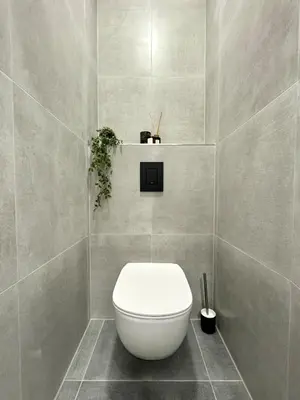 a bathroom with a white toilet in a room at Rentero modern Apartment, 10 minutes Charles bridge, Prague in Prague