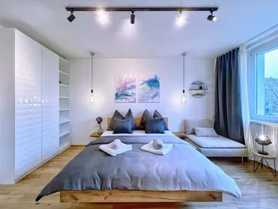 a bedroom with a large bed and a couch at Jana's WOW apt, 3 room, free parking, 15'Airpt, 25'City in Prague
