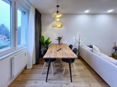 a living room with a wooden table and a couch at Jana's WOW apt, 3 room, free parking, 15'Airpt, 25'City in Prague