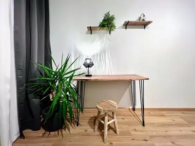 a table and a stool in a room with plants at Jana's WOW apt, 3 room, free parking, 15'Airpt, 25'City in Prague