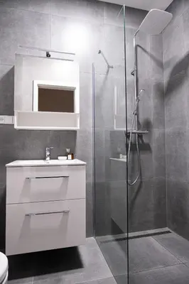 a bathroom with a white sink and a shower at Rentero Royal blue Wenceslas Apartment, Prague in Prague