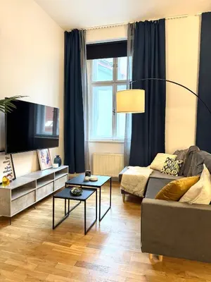 a living room with a couch and a table at Rentero Royal blue Wenceslas Apartment, Prague in Prague