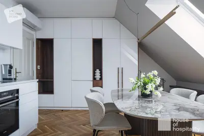 a kitchen with a glass table and chairs at MY SECOND HOME by House of Hospitality in Prague