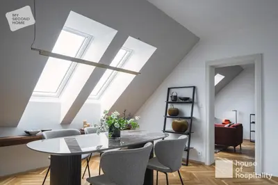 a dining room with a table and chairs at MY SECOND HOME by House of Hospitality in Prague
