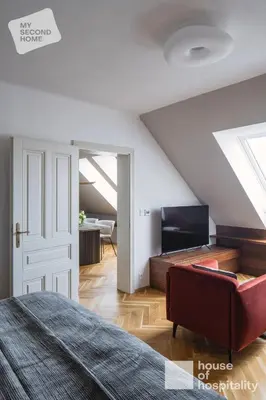 a bedroom with a bed and a living room at MY SECOND HOME by House of Hospitality in Prague