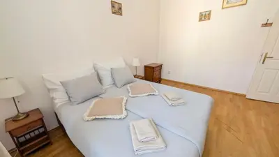 a large white bed with towels on top of it at Riverside Gem w Balcony View in Prague